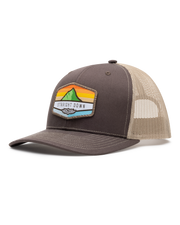 El Toro Hat in Brown, side view featuring a brown structured trucker cap with a woven mountain sunset landscape patch and Straight Down logo on the front panel, with tan mesh back panels and tan contrast stitching on the brim