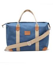 Weekender Bag in Moonlight, front product view featuring a blue waxed canvas body with tan canvas handles, tan leather trim accents, adjustable shoulder strap, and Straight Down logo patch