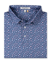 Men's Hold Em Polo in Moonlight, folded flat lay front view featuring an allover casino-themed print with playing cards, card suits, poker chips, dice, and cocktail glasses in pink and lavender on a slate blue base