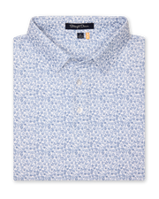 Men's Dog Pound Polo in Moonlight, folded flat lay front view featuring a white short sleeve polo with an all-over scattered dog face and bone print in navy
