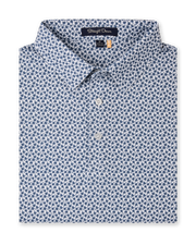 Folded Date Palm Polo in New Indigo with a white base, navy palm tree print, and three-button placket