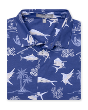 Islamorada Full Button Polo in Skipper, folded flat lay front view featuring a blue base with an all-over white nautical print of marlin, sailfish, coral, palm trees, and fishing rods