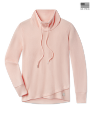 A light peach waffle-knit mock neck sweater with a drawstring.