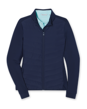 Women's Ida Hybrid Jacket in New Indigo, flat lay front view featuring a hybrid construction with a quilted chevron-pattern front body and solid stretch sleeves, full zip closure, stand-up collar, and ribbed cuffs, layered over a light blue collared shirt