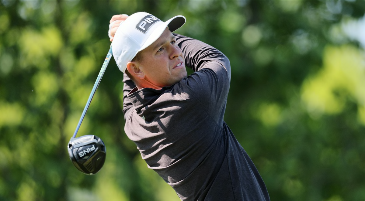 Sam Stevens, Straight Down PGA Tour ambassador, follows through on a driver swing wearing a Straight Down long sleeve against a lush green background.