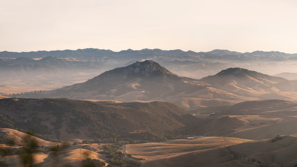 Bishop Peak rises through the morning haze above the golden hills surrounding San Luis Obispo, home of Straight Down.