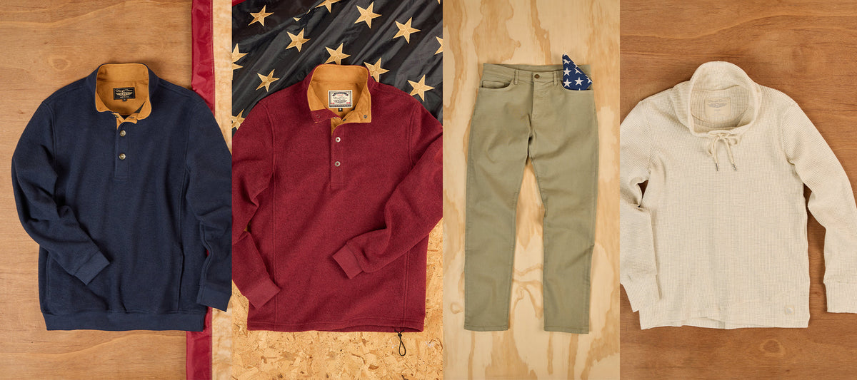 Four Straight Down Made in the USA pieces — navy and burgundy Leucadia fleece pullovers, olive Henderson pant, and cream Misty waffle knit — displayed as flat lays against a patriotic flag and wood backdrop.