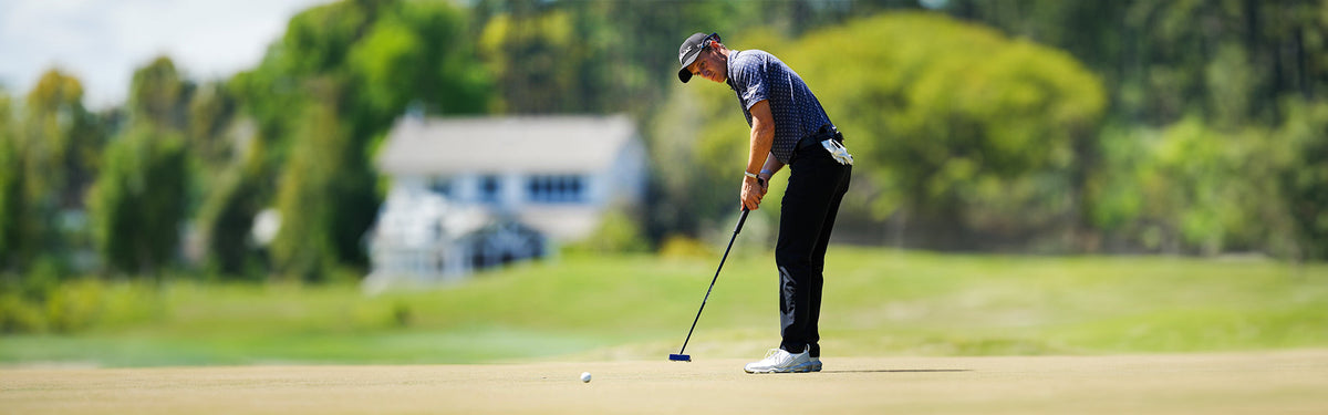 Tim Widing concentrates over a putt wearing a Straight Down polo