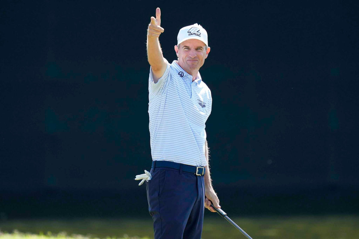 Steven Alker points to the crowd with a smile after holing a putt, wearing a Straight Down striped polo at the Charles Schwab Cup Championship.