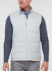 Men's Canyon Vest in Silver, front on-model view featuring a light gray quilted puffer vest with a full zip closure, styled with a charcoal heather long sleeve and gray pants