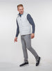 Men's Canyon Vest in Silver, side on-model view featuring a light gray quilted puffer vest with a full zip closure and front zip pocket, styled with a charcoal heather long sleeve, gray pants, and dark shoes