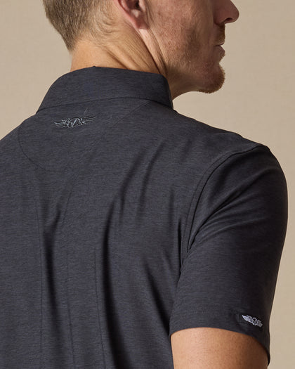 Close-up back detail of Dodge Polo in Dark Black showing embroidered logo and fabric texture