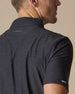 Close-up back detail of Dodge Polo in Dark Black showing embroidered logo and fabric texture