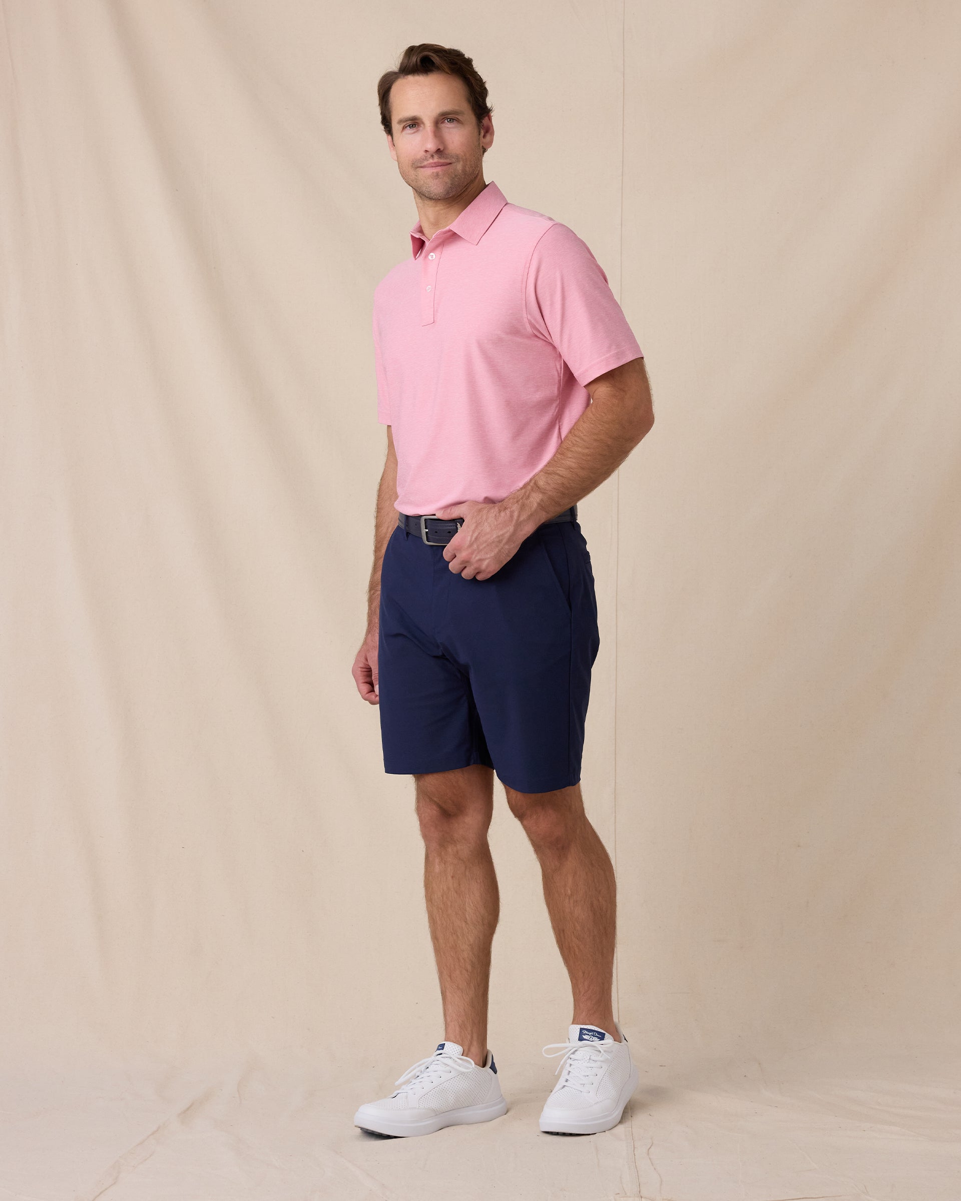 Dodge Polo in Pink, full-body model lifestyle view styled with shorts