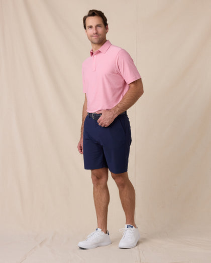 Dodge Polo in Pink, full-body model lifestyle view styled with shorts