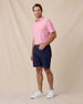 Dodge Polo in Pink, full-body model lifestyle view styled with shorts