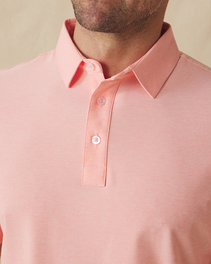 Close-up front detail of Dodge Polo in Spritz Orange showing collar and button placket