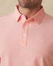 Close-up front detail of Dodge Polo in Spritz Orange showing collar and button placket