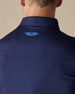 Men’s Olympic Polo in Indigo Blue, close-up back collar detail with embroidered logo