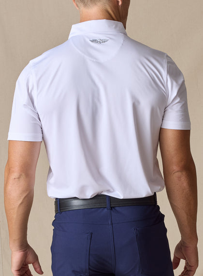 Men’s Olympic Polo in White, back view worn with navy golf pants