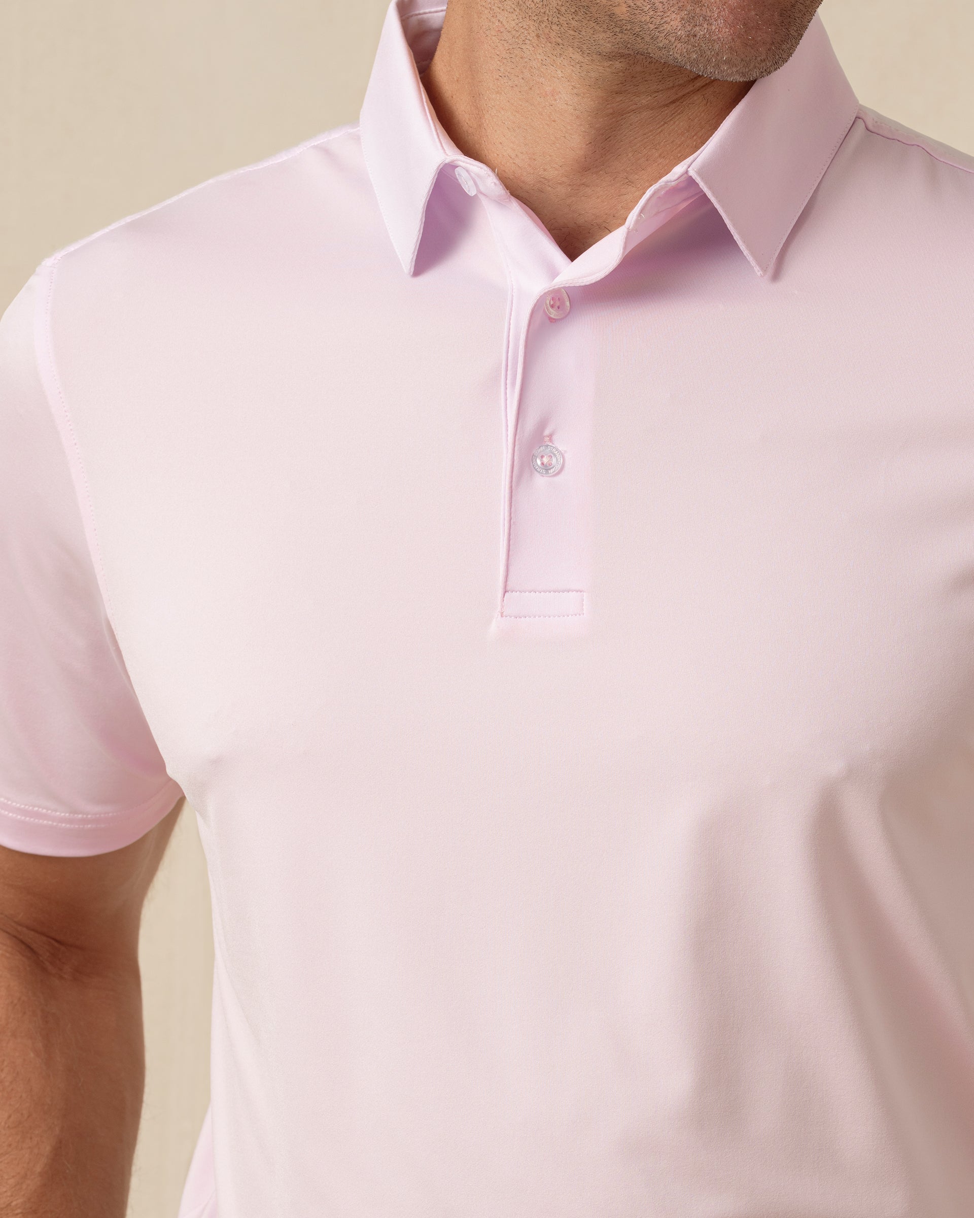 Close-up of men’s lilac polo collar and button placket with clean, minimal design