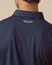 Close-up of men’s blue polo sleeve showing smooth fabric and logo tab detail