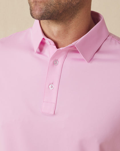 Close-up of men’s pink polo collar and button placket with clean, minimal design