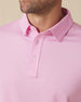 Close-up of men’s pink polo collar and button placket with clean, minimal design
