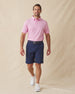 Men’s pink polo styled with navy shorts, brown belt, and white sneakers