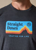 Straight Down Starsky Tee in Charcoal, on model close-up view showing retro mountain graphic detail with blue sky background, orange and red layered peaks, and Crafted for Life text