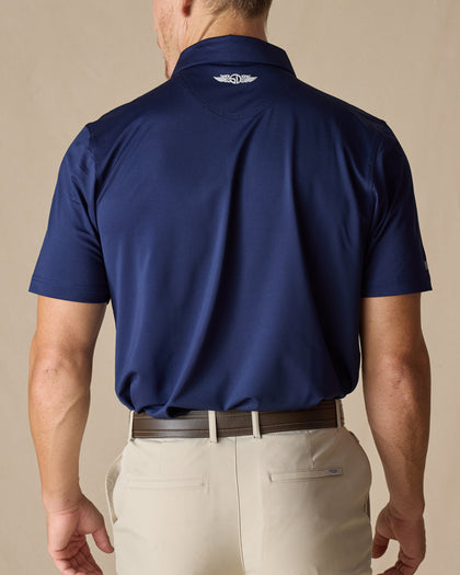 Men’s Sullivan Polo in new indigo worn with khaki pants, back view
