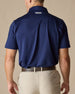 Men’s Sullivan Polo in new indigo worn with khaki pants, back view