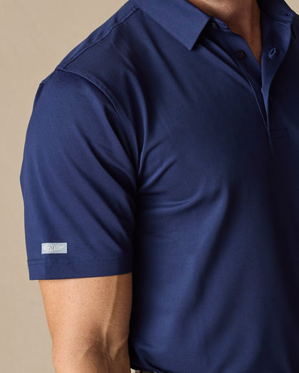 Close-up of the Sullivan Polo sleeve logo tab in new indigo