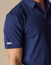 Close-up of the Sullivan Polo sleeve logo tab in new indigo