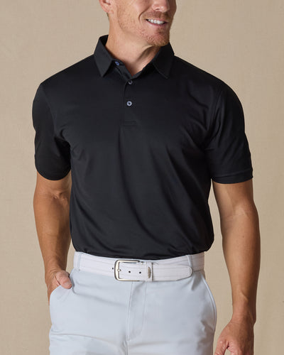 Men’s Sullivan Polo in Black styled with light gray golf pants, front view