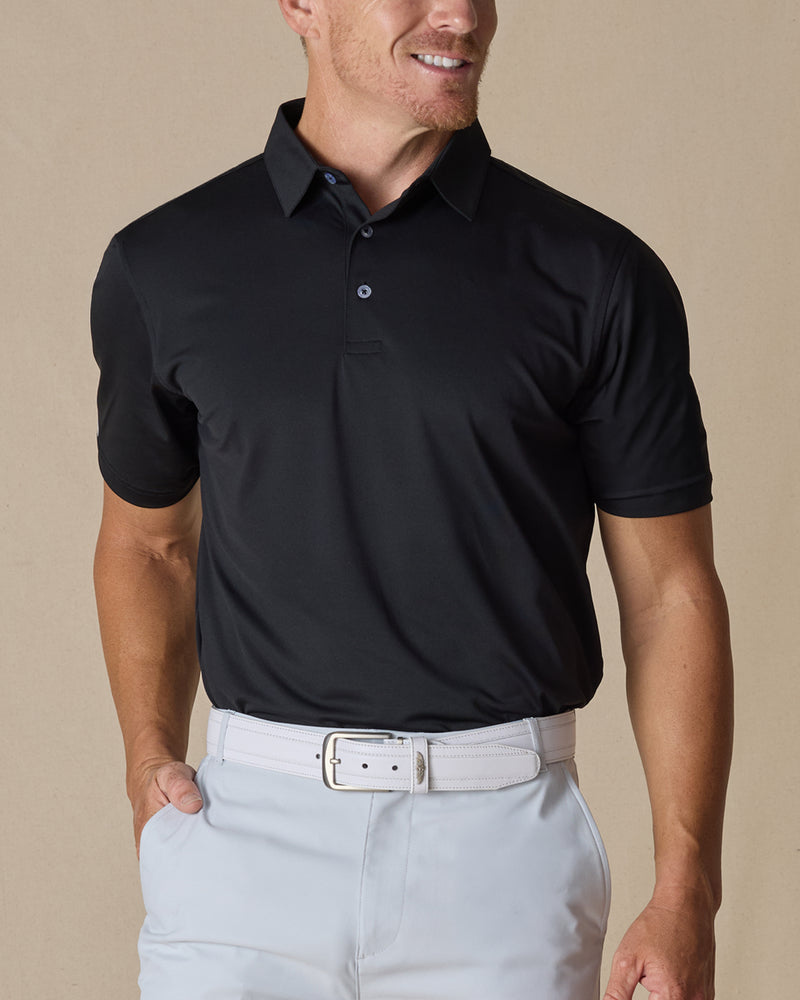 Men’s Sullivan Polo in Black styled with light gray golf pants, front view
