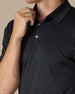 Close-up detail of the Sullivan Polo in Black highlighting the smooth performance fabric, collar, and button placket