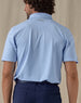 Men’s Sullivan Polo in Carolina Blue, back view worn with navy golf pants