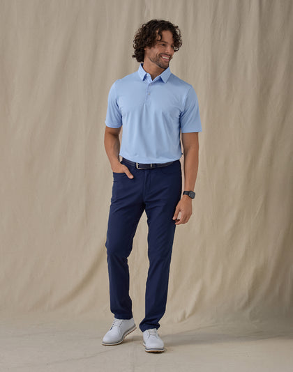 Men’s Sullivan Polo in Carolina Blue, full-body styling view with navy golf pants and white golf shoes