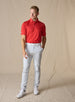 Full-body view of the Sullivan Polo in Flag Red paired with light gray pants