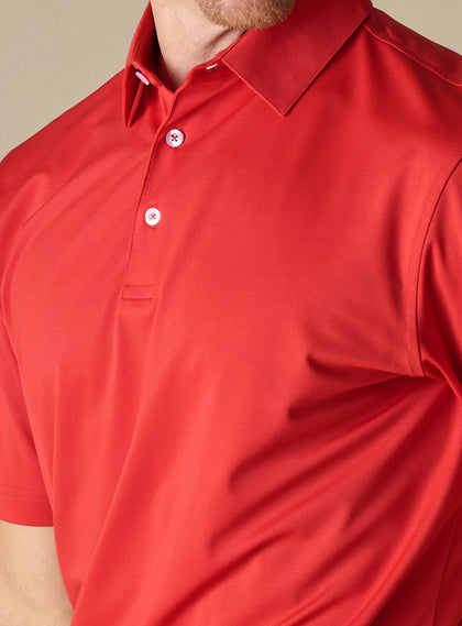 Close-up detail of the Sullivan Polo in Flag Red highlighting the smooth performance fabric and three-button placket