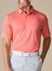 Men’s Sullivan Polo in gala orange styled with light gray golf pants, front view