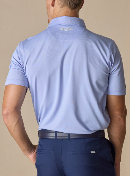 Men’s Sullivan Polo in lavender, back view worn with navy golf pants