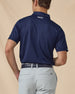 Back view of the Sullivan Polo in New Indigo with signature logo detail below the collar