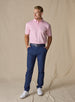 Men’s Sullivan Polo in Pink Lemonade, full-body styling view with navy golf pants and white golf shoes