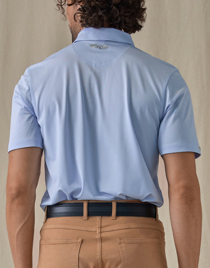 Men’s Sullivan Polo in Powder Blue, back view worn with khaki pants
