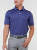 Men’s Sullivan Polo in skipper blue, front view worn with gray golf pants