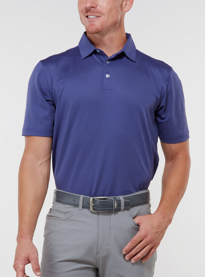 Men’s Sullivan Polo in skipper blue, front view worn with gray golf pants