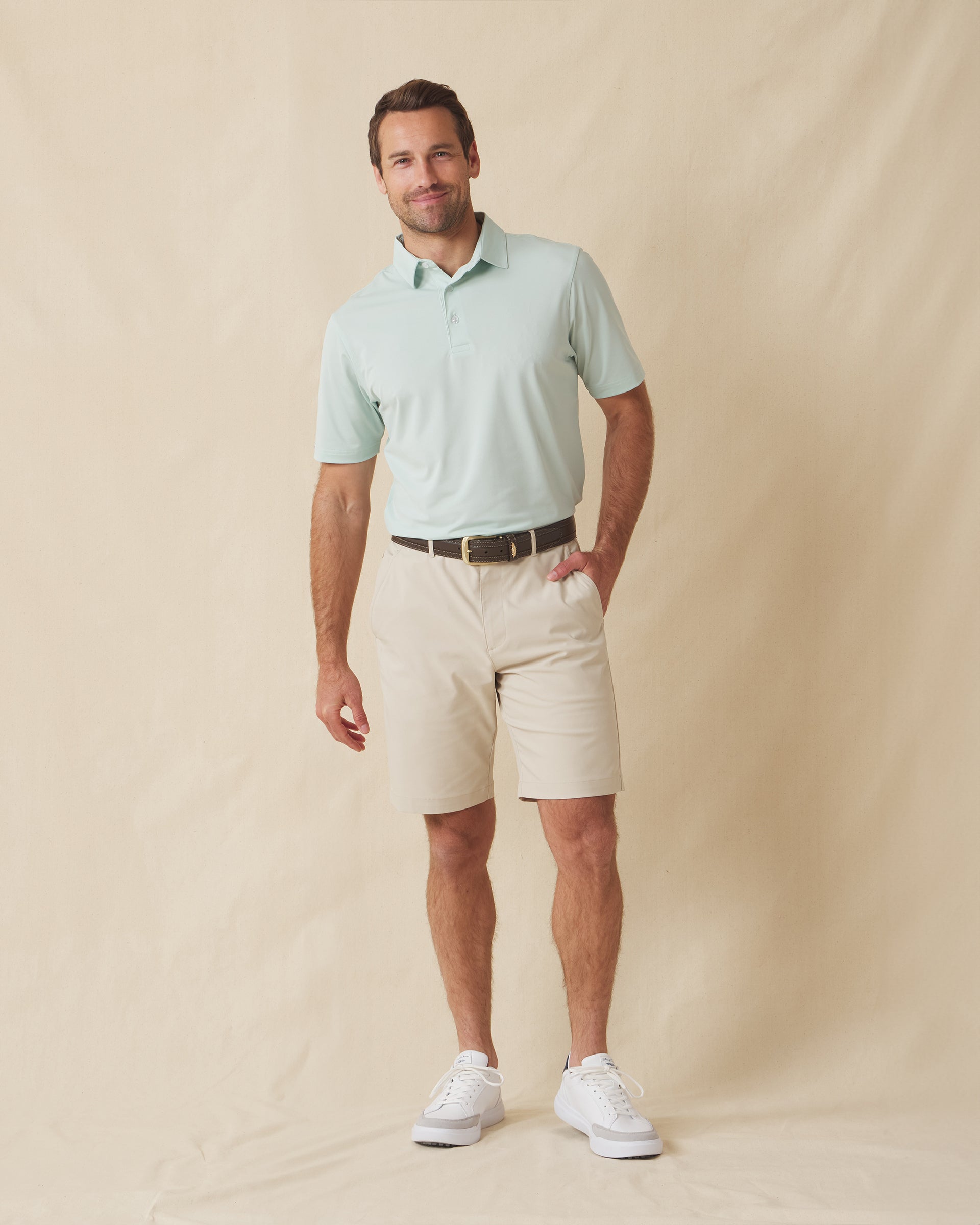 Men’s Sullivan Polo in celery green worn with khaki shorts, full-body view