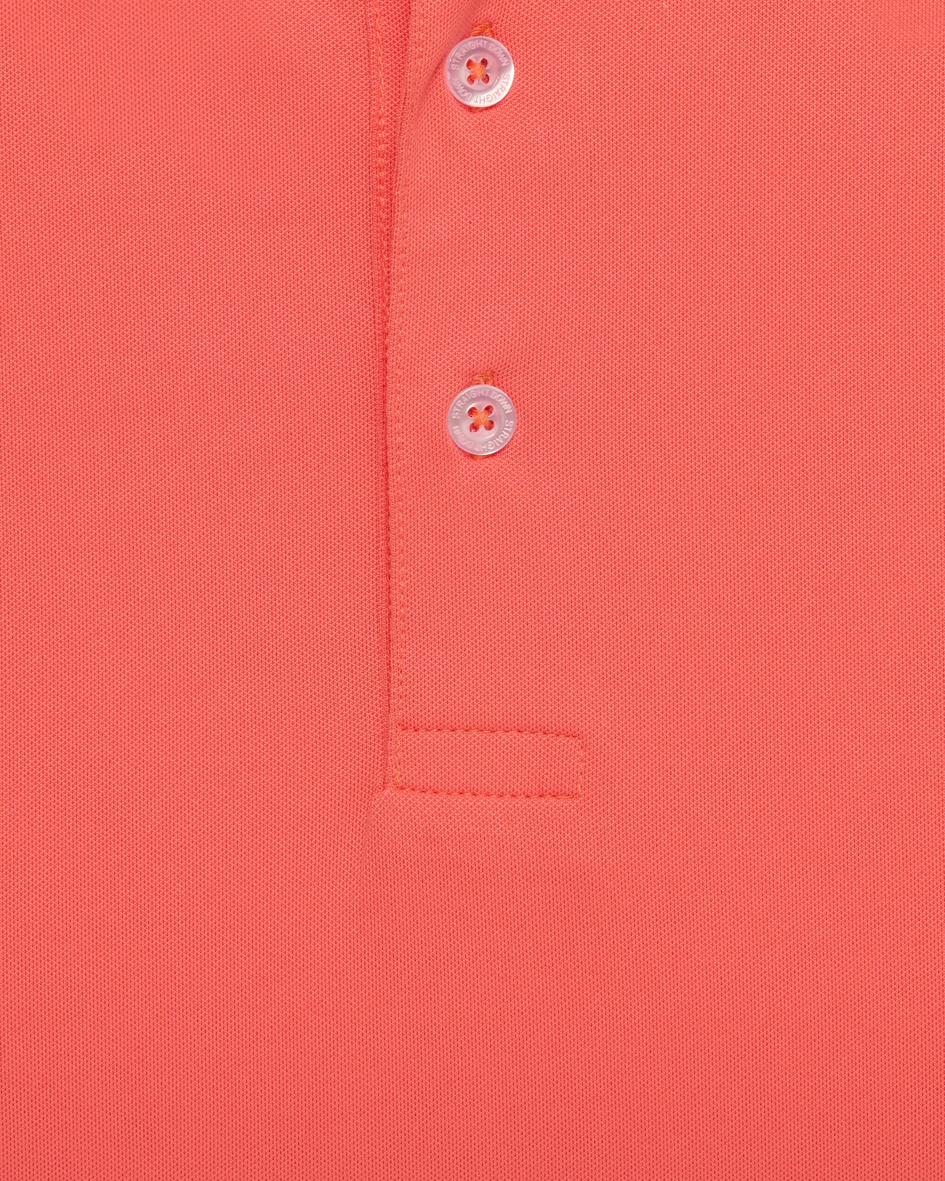 Close-up of orange golf polo fabric with button placket detail